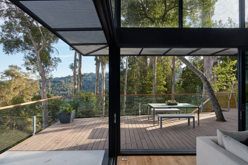 The Hillside House Wrapped in Rusted Steel with a Bright Yellow Surprise