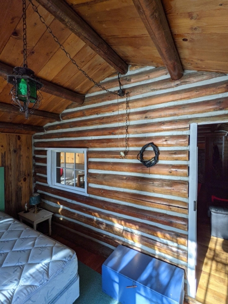 A Century-Old Log Cabin Becomes the Living Room of a New Lake House