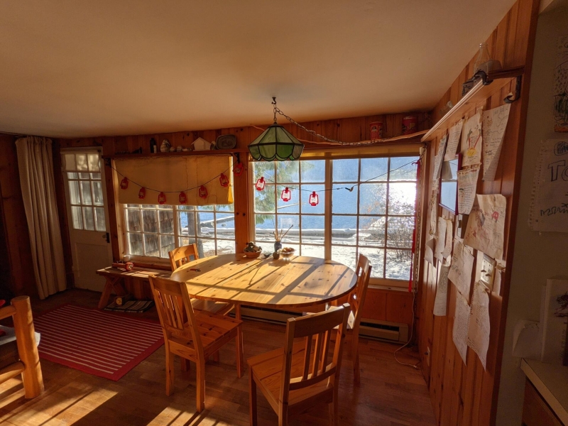 A Century-Old Log Cabin Becomes the Living Room of a New Lake House