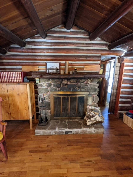 A Century-Old Log Cabin Becomes the Living Room of a New Lake House