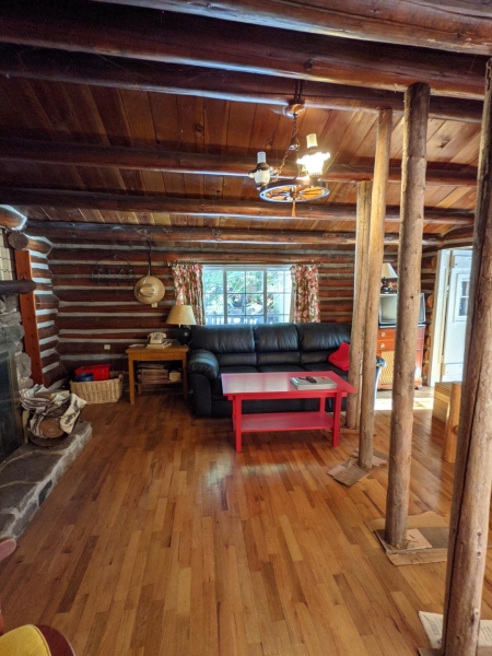 A Century-Old Log Cabin Becomes the Living Room of a New Lake House
