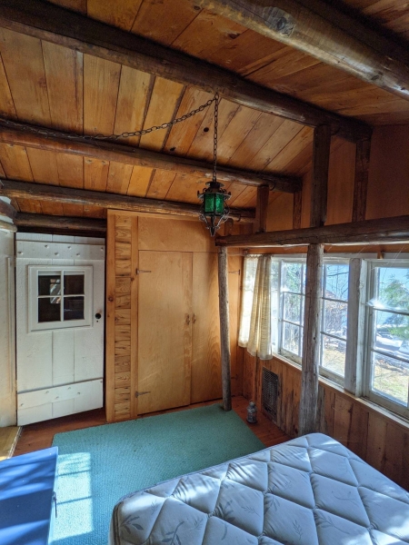 A Century-Old Log Cabin Becomes the Living Room of a New Lake House