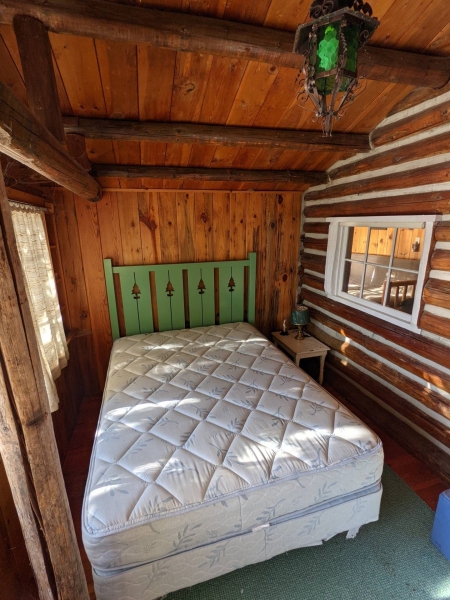 A Century-Old Log Cabin Becomes the Living Room of a New Lake House