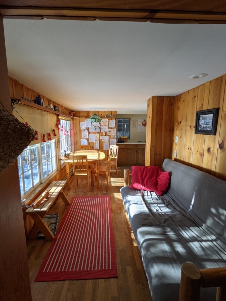 A Century-Old Log Cabin Becomes the Living Room of a New Lake House