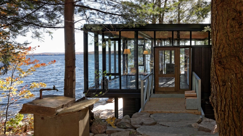 A Modern Boathouse Built by Hand on a Canadian Lake Includes a Living Space